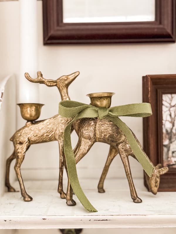 Candle holder reindeer with bow decorated for Christmas.