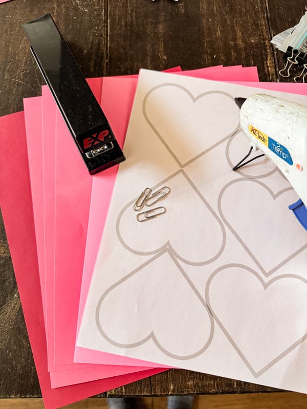 Supplies needed for DIY 3D Paper Hearts Valentine's Day Decoration craft.