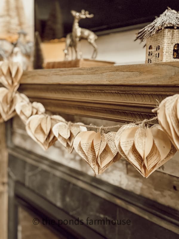 3D Paper Hearts made from old book pages added to the farmhouse mantel with jute twine.  