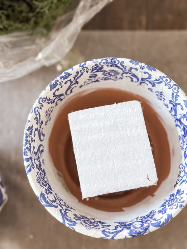 styrofoam block in napkin decoupage blue and white container.