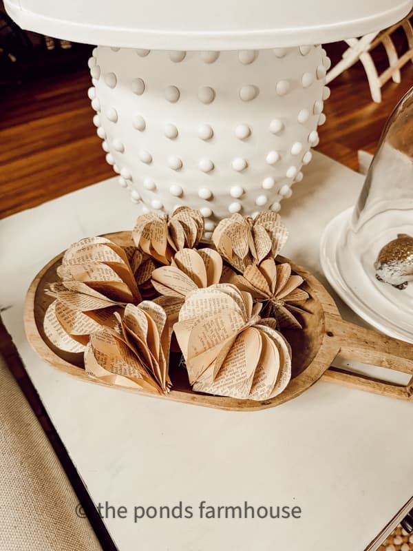 wooden dough bowl filled with 3D Valentine Hearts made with old book pages