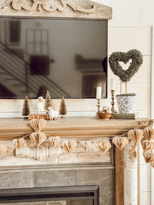 Two Valentine's Day Crafts on Shabby Chic Mantel - Paper heart garland and Moss Heart topiaries.  