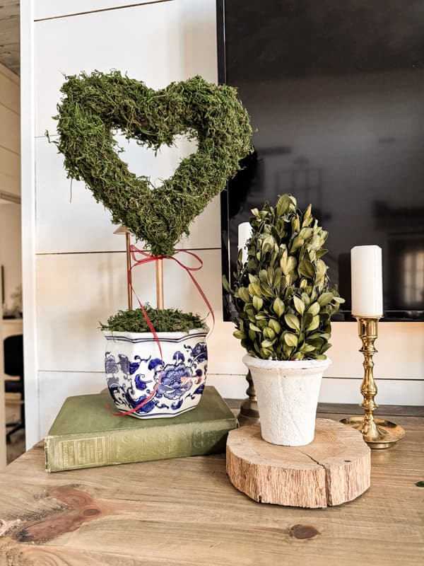 1 DIY Heart Topiaries for Valentine's Day Decor on Shabby Chic Mantel with boxwood topiary and brass candlestick holders